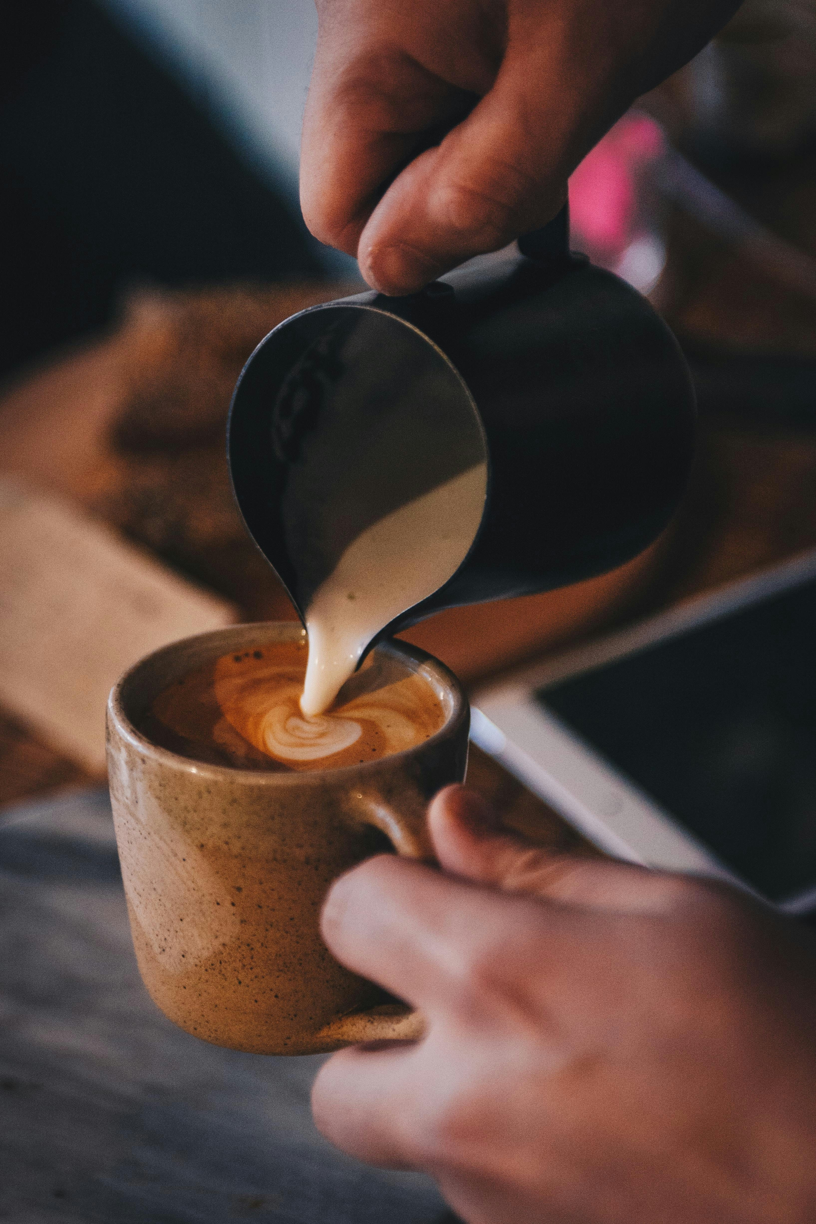 Pouring milk into coffee
