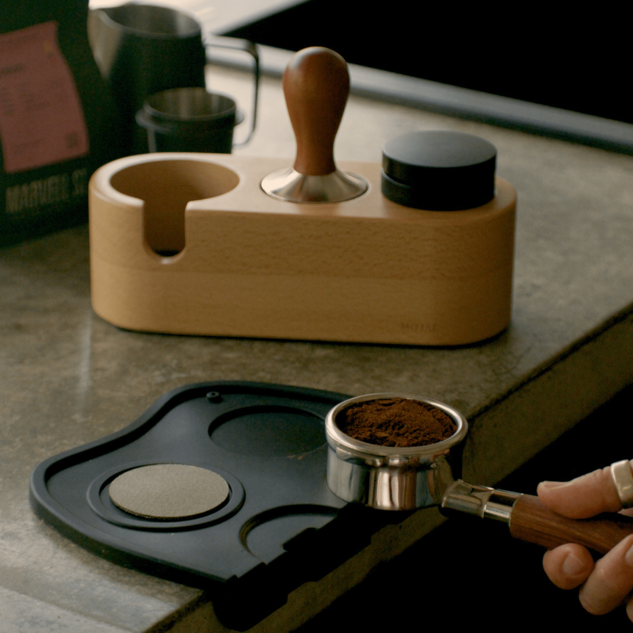 Wooden coffee tamper and distributor on a kitchen benchtop