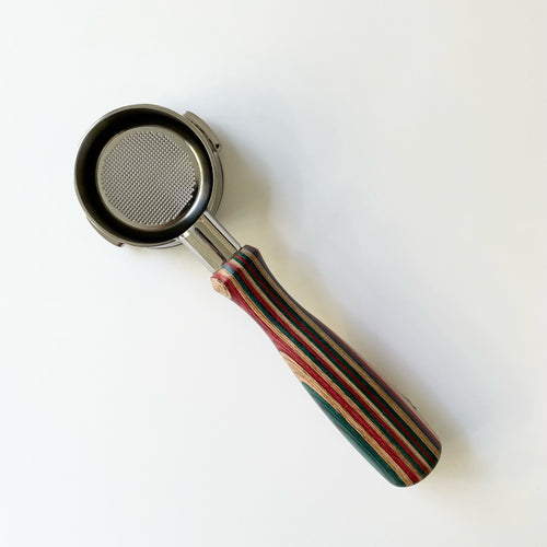 A bottomless portafilter with a premium wooden handle and stainless steel body, designed for Breville series 9 coffee machines.